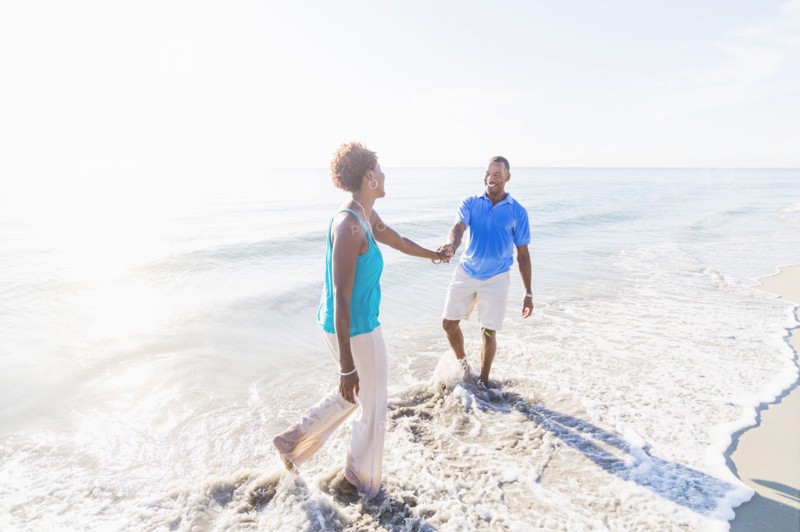 Mature couple walking on beach