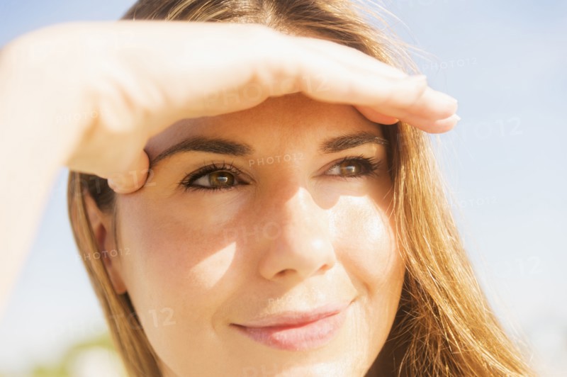 Woman shielding eyes