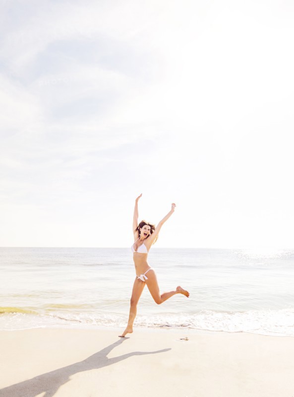 Woman jumping on beach