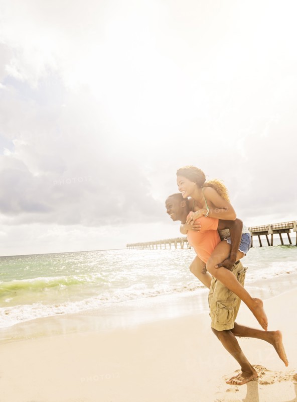 Young couple playing on beach