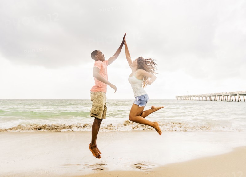 Young couple playing on beach