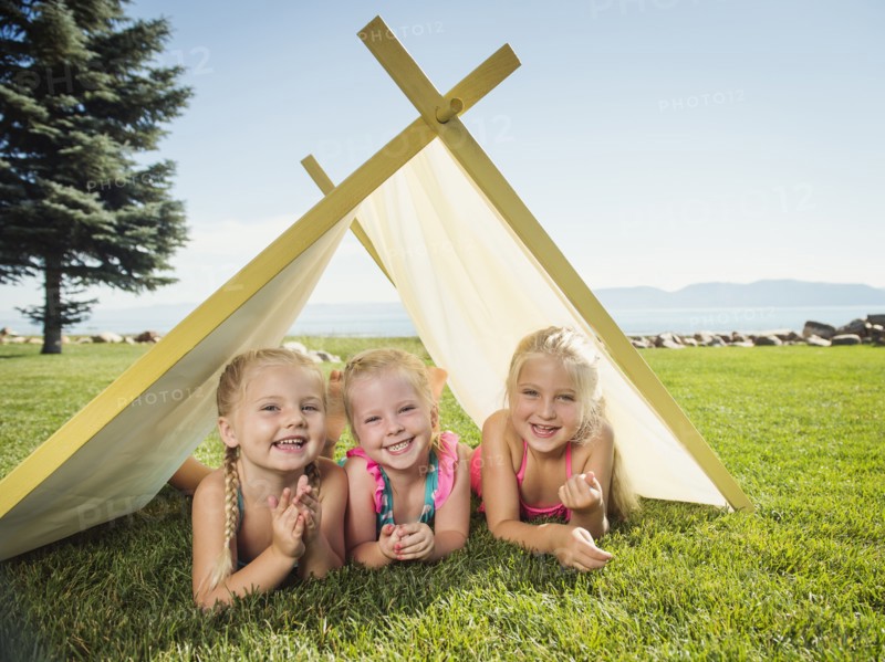 Three girls (2-3, 4-5) playing in tent