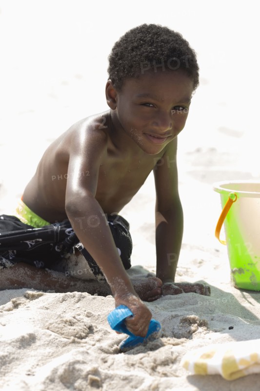 Portrait of boy (4-5) playing on beach