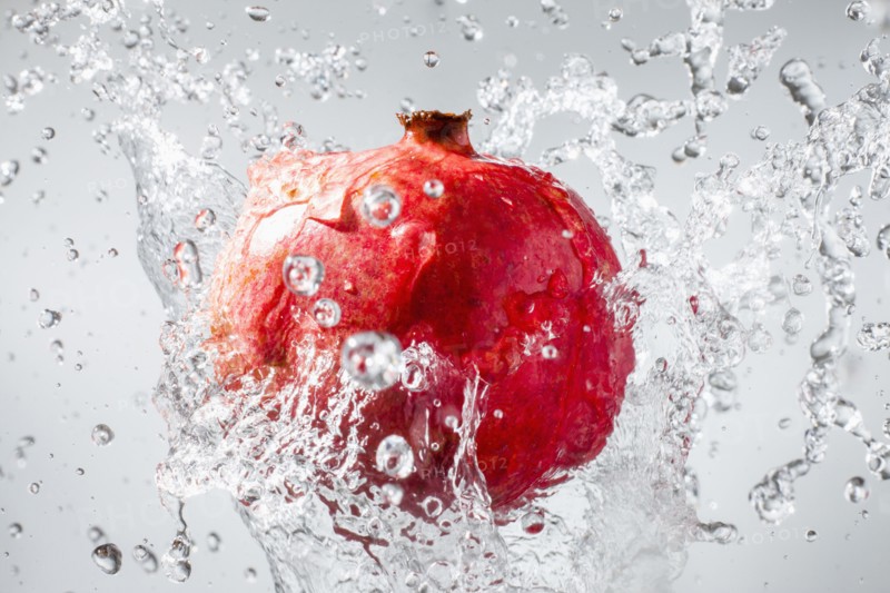 Droplets splashing on pomegranate