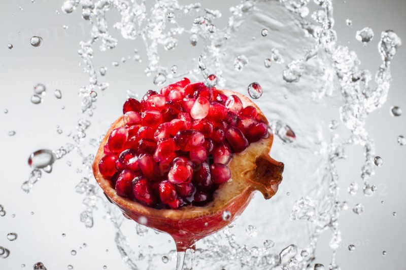 Droplets splashing on pomegranate