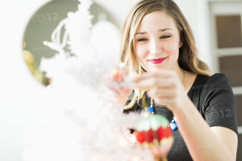 Young woman holding Christmas ornament