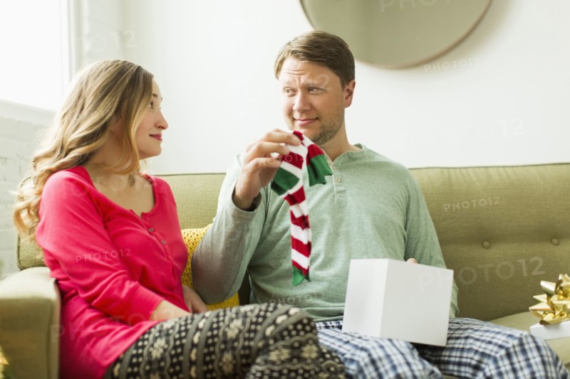 Man holding unwanted Christmas gift