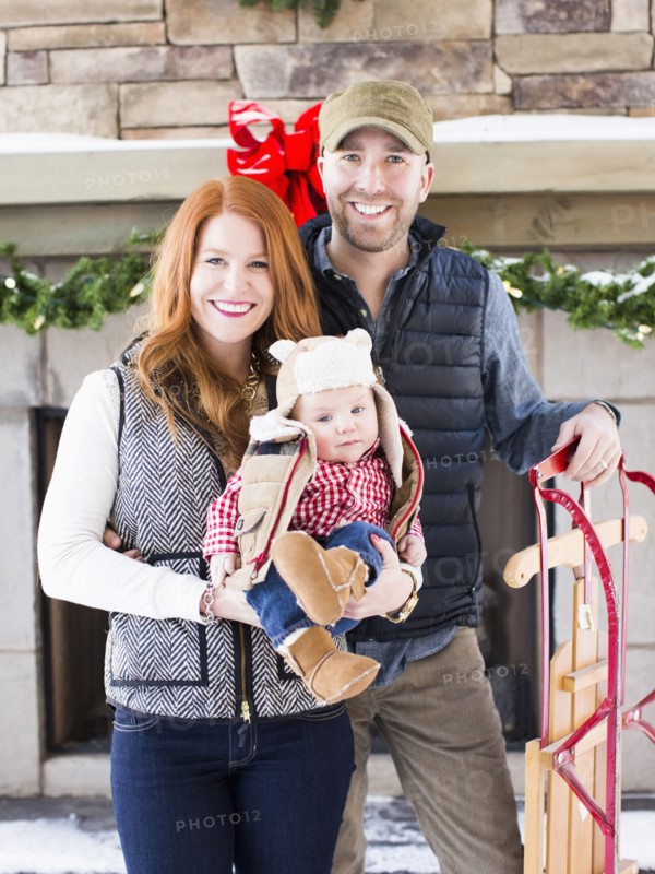 Portrait of family with one child (2-5 months) and sledge