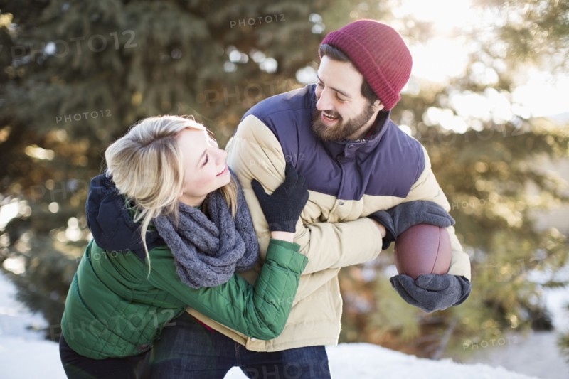 Couple playing American football