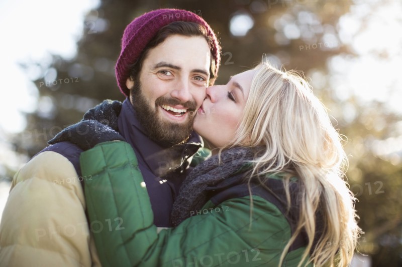 Woman kissing man's cheek
