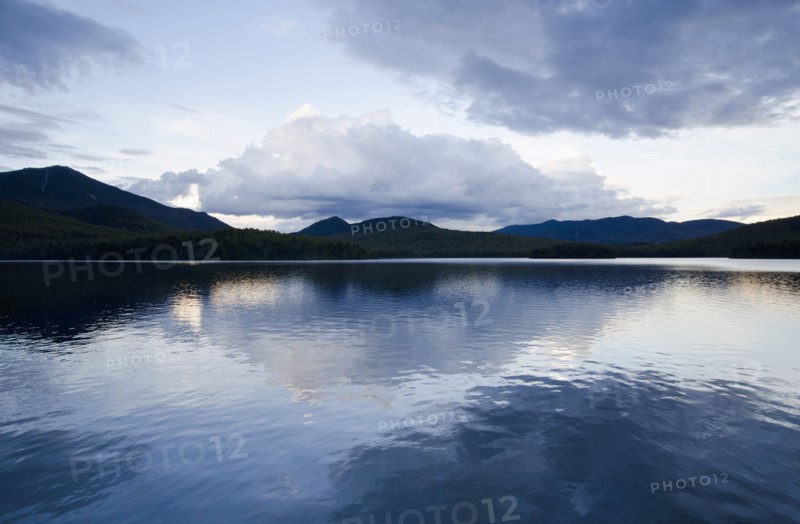 Clouds reflecting in lake at dusk