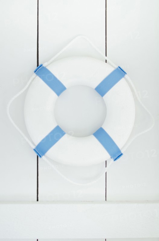 White lifebelt hanging on white wall