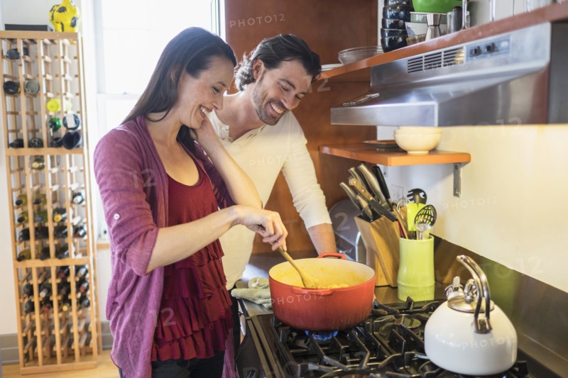 Happy couple preparing dinner.