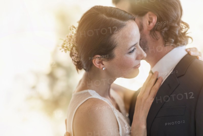 Bride and groom dancing cheek to cheek.