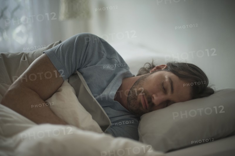 Man sleeping in bed.