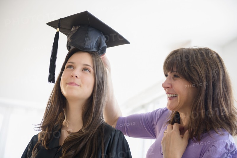 Teenage girl (14-15) getting ready for graduation ceremony