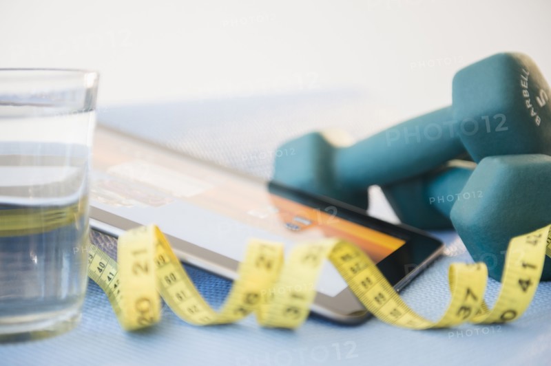 Dumbbells, tape measure and digital tablet