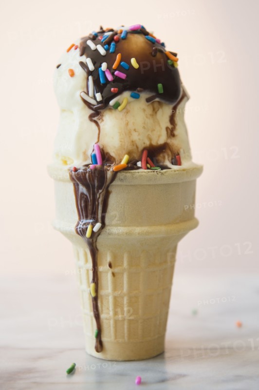 Studio shot of ice cream cone with chocolate sauce