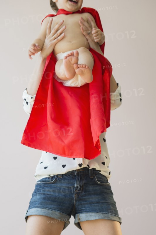 Studio shot of mother holding baby daughter (18-23 months)