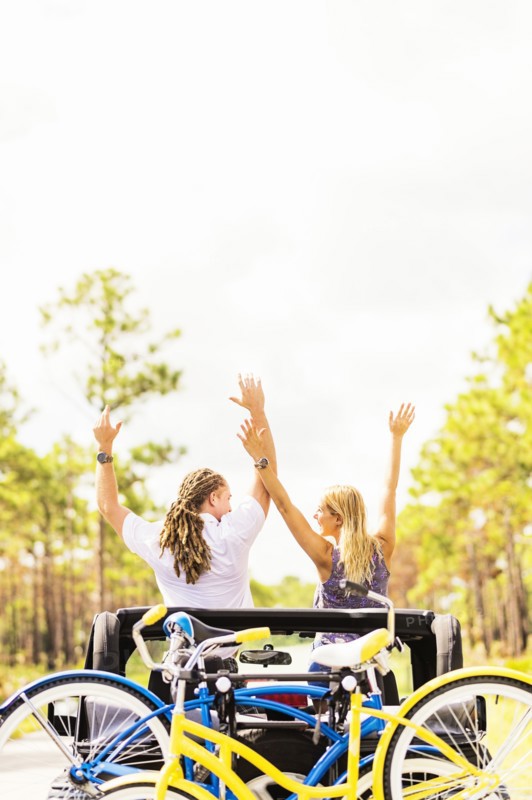 Couple rising hands in car
