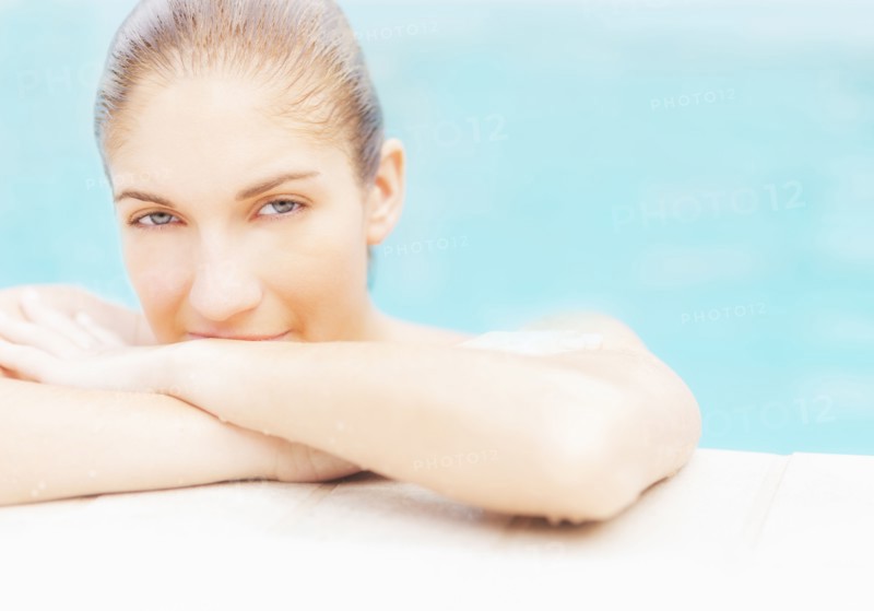Portrait of woman on edge of swimming pool