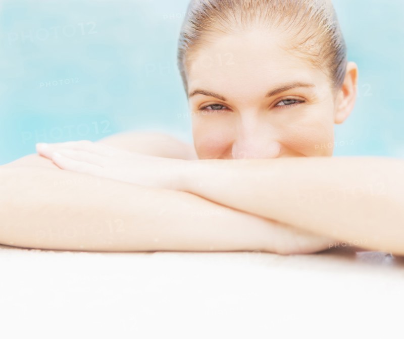 Portrait of woman on edge of swimming pool