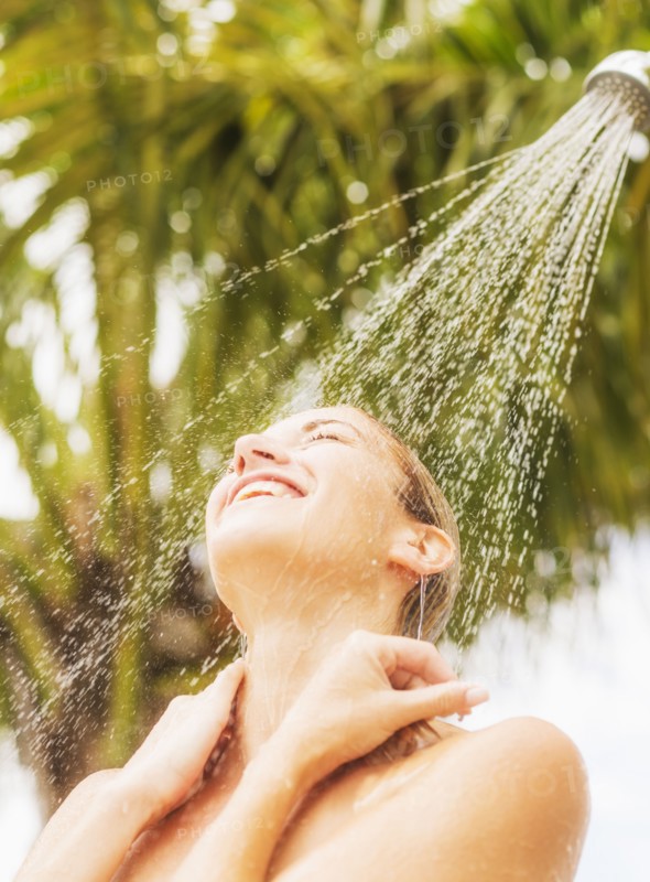 Woman taking shower outdoors