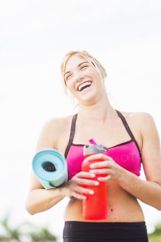 Portrait of smiling woman drinking water
