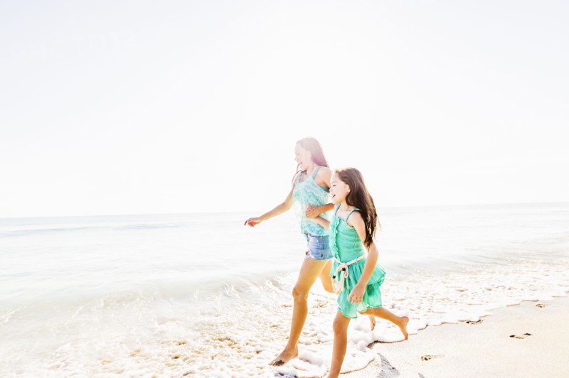 Mom and daughter (6-7) spending time together on beach