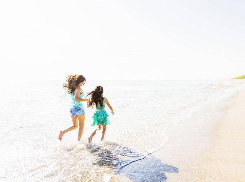 Mom and daughter (6-7) spending time together on beach