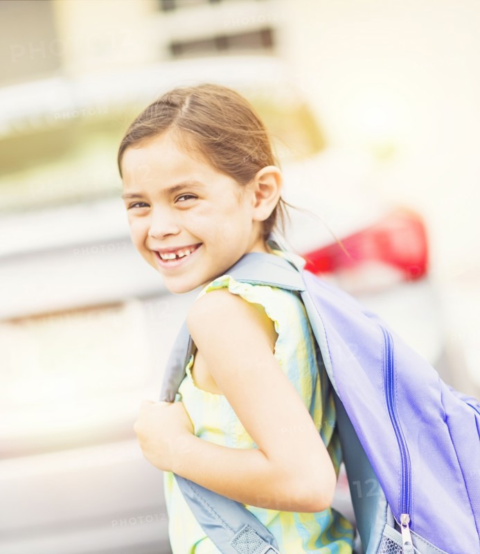 Portrait of smiling student (6-7) outdoors