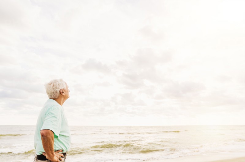 Side view of senior man standing on beach