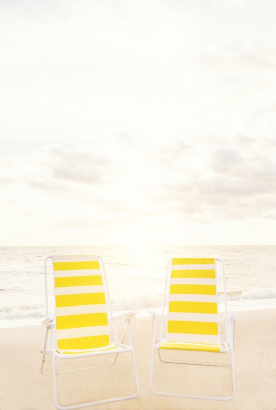 Two empty chairs on beach