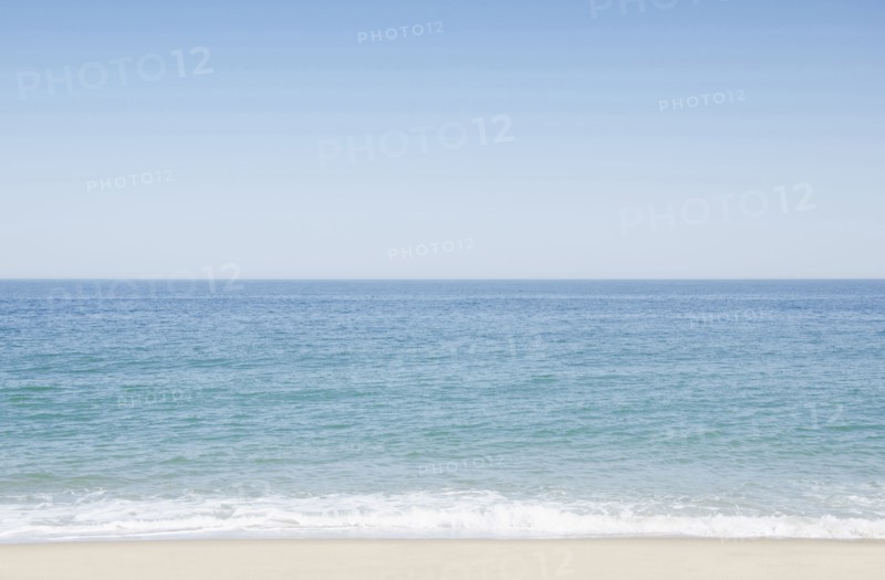 Seascape with surf on sandy beach