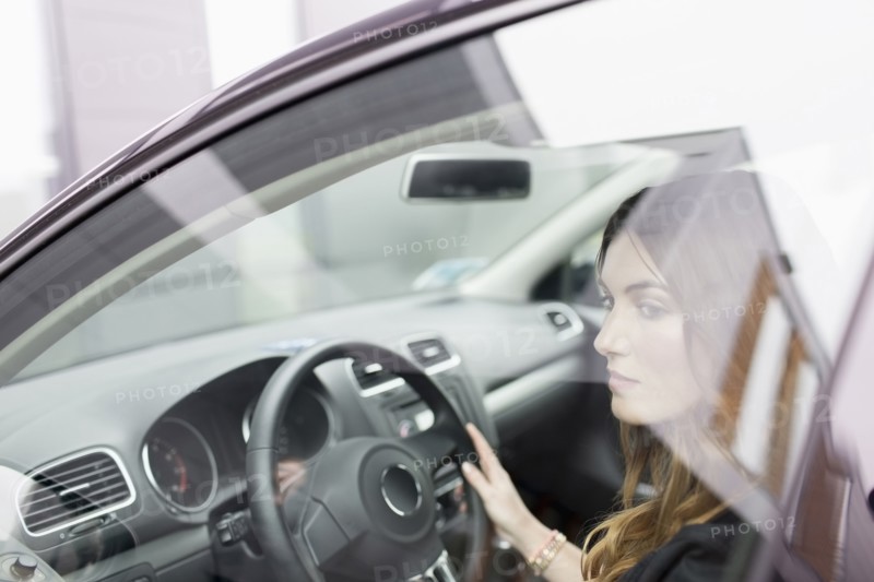 Young woman sitting in car