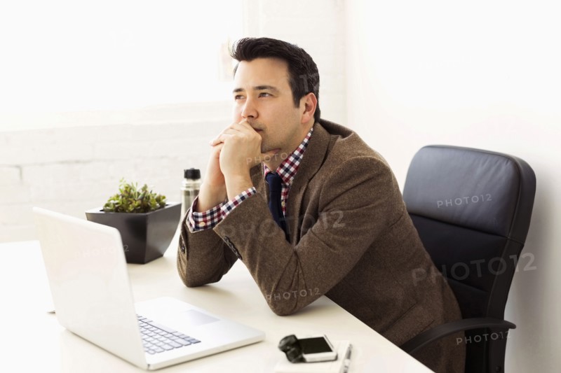 Businessman sitting in office and thinking