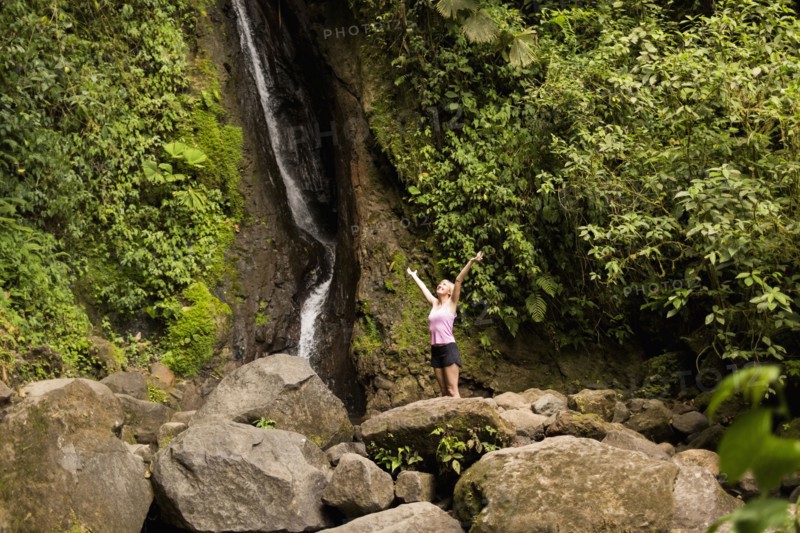 Woman under waterfall