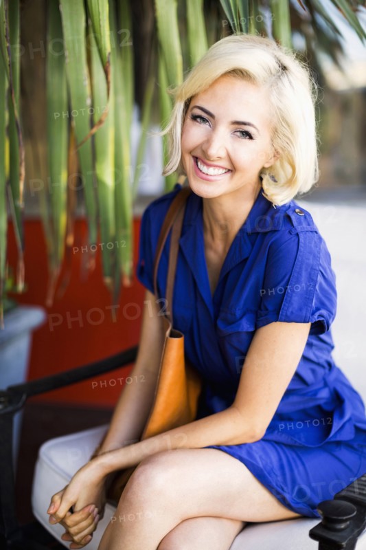Woman with dyed hair sitting and smiling to camera