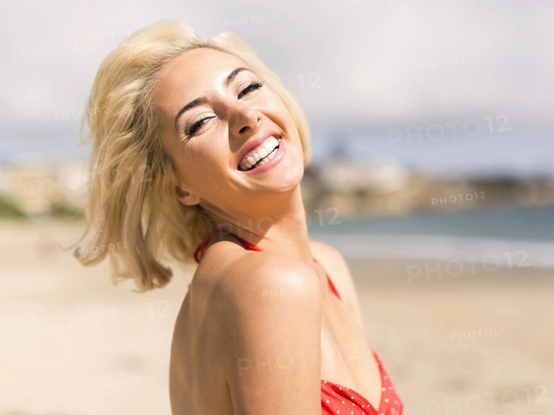 Portrait of blond woman on beach