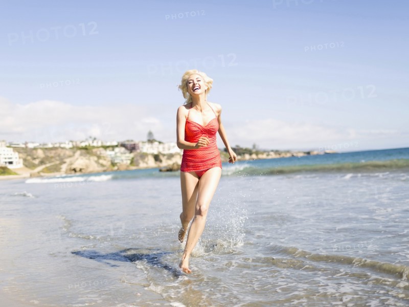 Blond woman running on beach