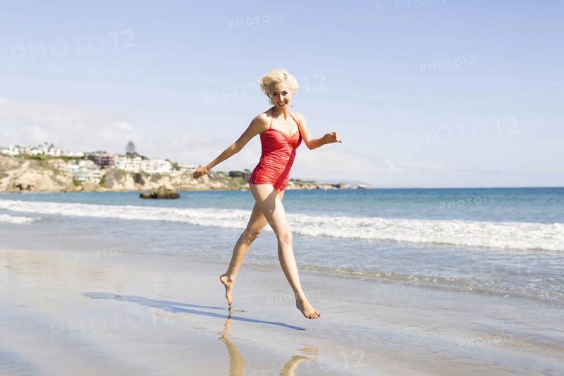 Blond woman running on beach