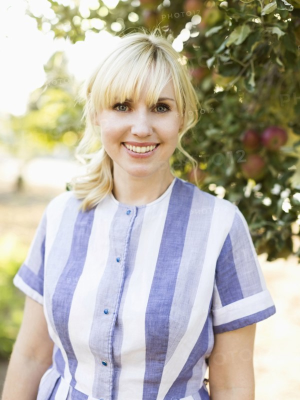 Portrait of blond woman in orchard
