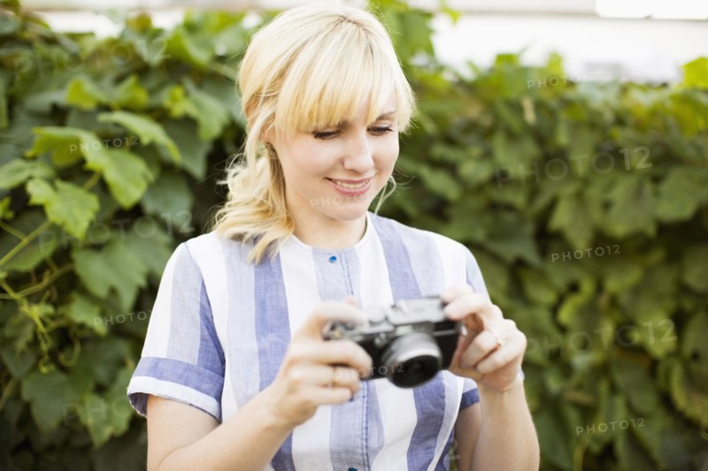 Blonde woman with digital camera
