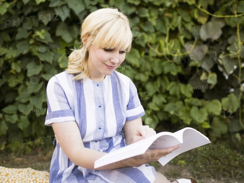 Woman reading book in garden
