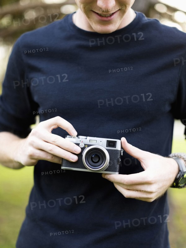 Young man holding camera