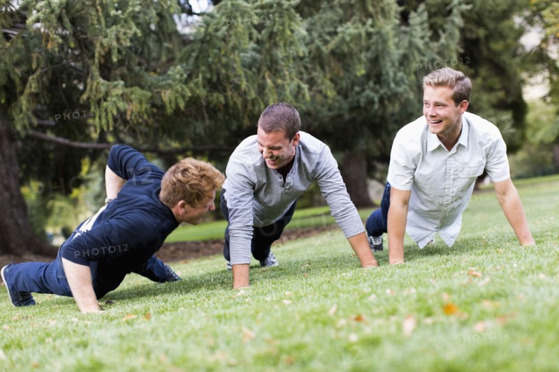 Young man doing push ups in park