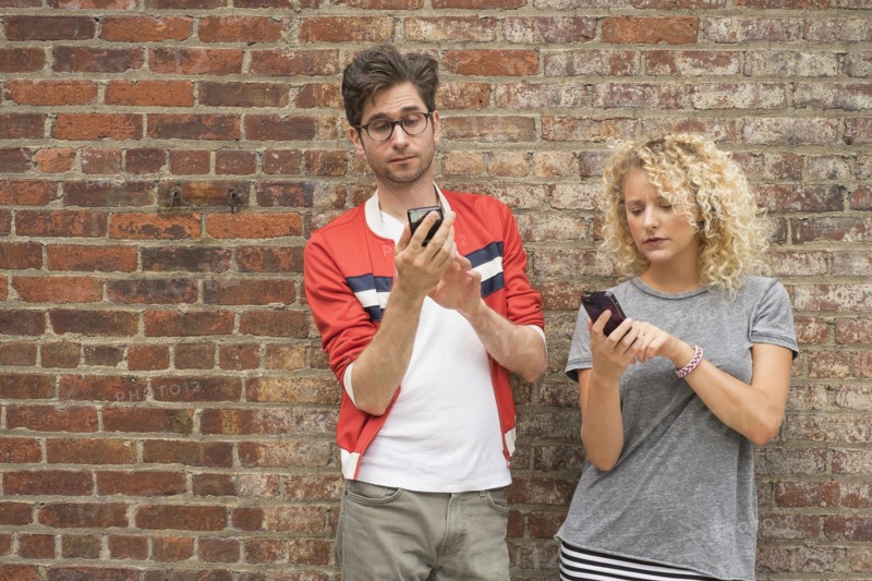 Couple using cell phones.