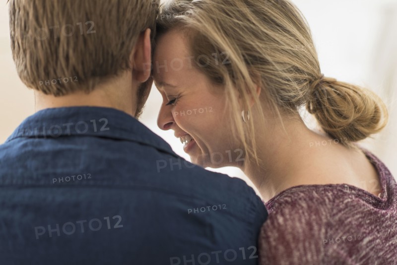 Close-up of smiling woman leaning on man.