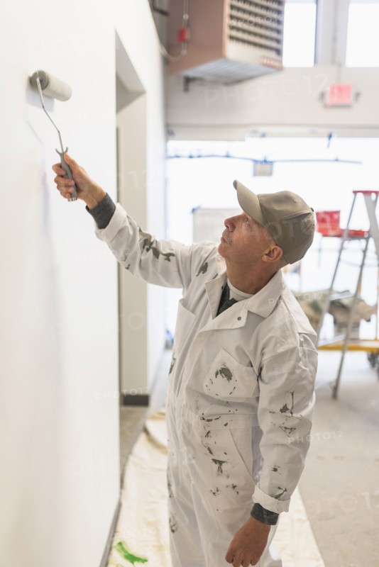 Manual worker painting wall.