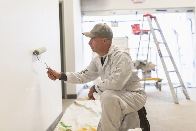 Manual worker painting wall.